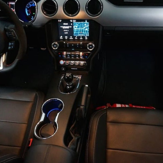 Ford Mustang cabin with a red fire extinguisher mounted on a KAP bracket at the base of the front seat