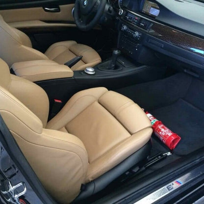 Mini Cooper / JCW cabin with a red fire extinguisher mounted on a KAP bracket at the base of the front seat