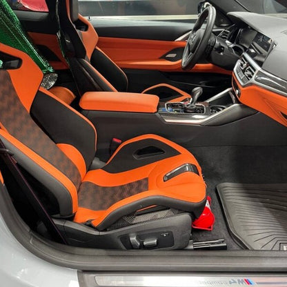 BMW X3 M cabin with a red fire extinguisher mounted on a KAP bracket at the base of the front seat