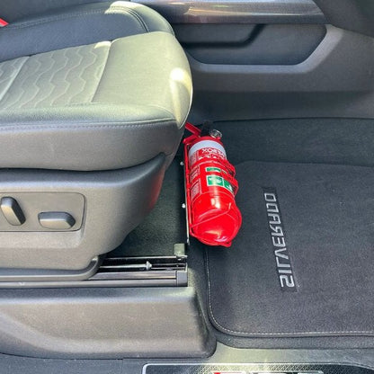 GMC Sierra 1500 cabin with a red fire extinguisher mounted on a KAP bracket at the base of the front seat
