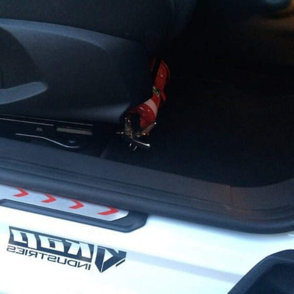 Ford Fiesta cabin with a red fire extinguisher mounted on a KAP bracket at the base of the front seat
