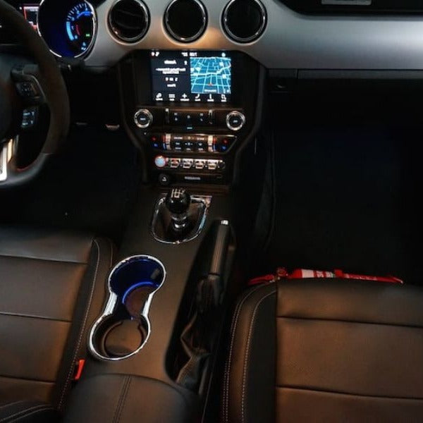 Ford Mustang cabin with a red fire extinguisher mounted on a KAP bracket at the base of the front seat