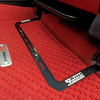 KAP fire extinguisher bracket bolted to the front seat rails of a Honda Civic Type R, shown before the extinguisher is fitted