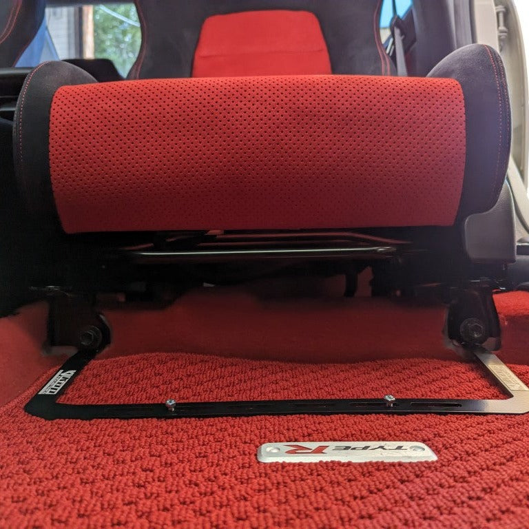 KAP fire extinguisher bracket bolted to the front seat rails of a Honda Civic Type R, shown before the extinguisher is fitted