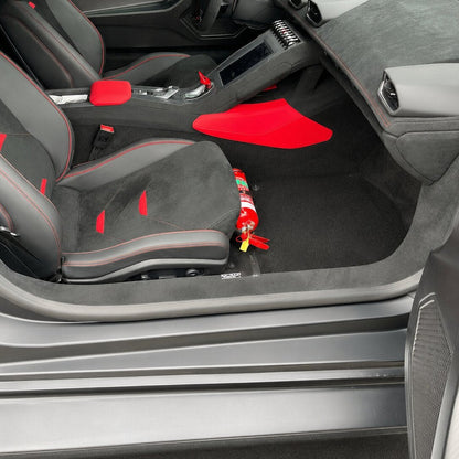 Audi R8 cabin with a red fire extinguisher mounted on a KAP bracket at the base of the front seat