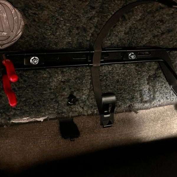 KAP bracket bolted to the right front seat rails of a Nissan 240SX, before the extinguisher is fitted