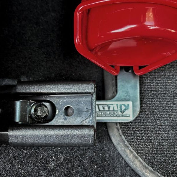 KAP fire extinguisher bracket bolted to the front seat rails of a Porsche 718 Boxster, before the extinguisher is fitted
