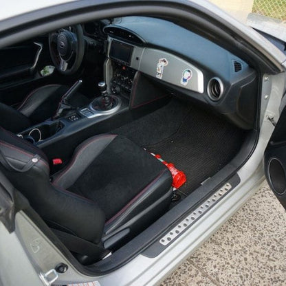 Toyota 86/GT86 cabin with a red fire extinguisher mounted on a KAP bracket at the base of the front seat