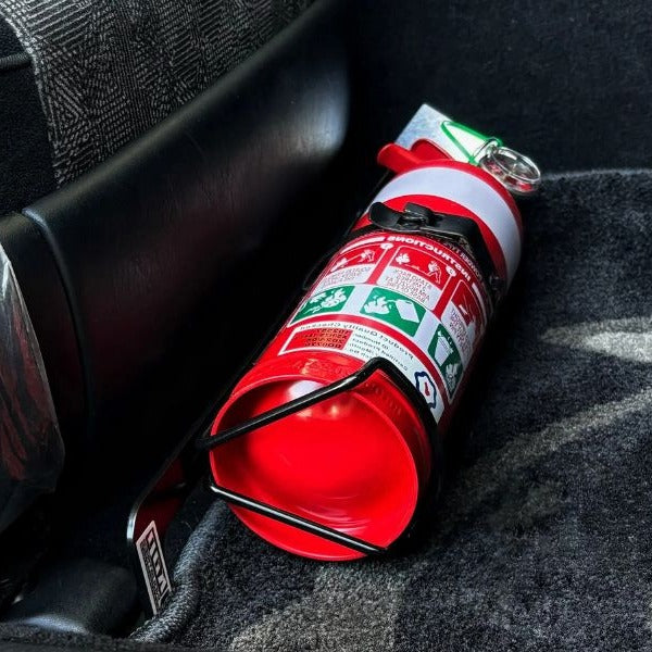 Close-up of a red fire extinguisher held in a KAP bracket at the base of the front seat in a Toyota Aristo / Lexus GS