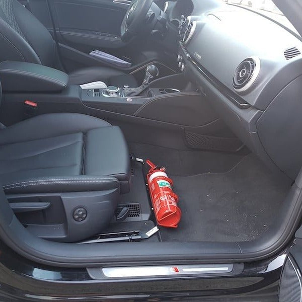 Volkswagen Tiguan cabin with a red fire extinguisher mounted on a KAP bracket at the base of the front seat