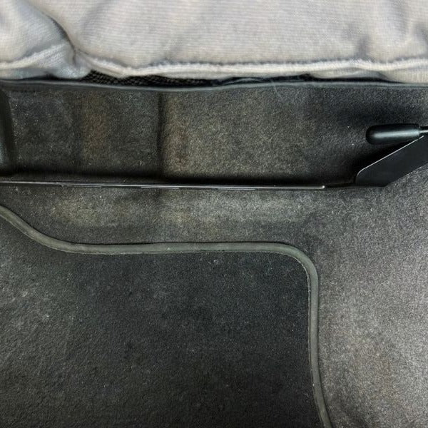 KAP bracket bolted to the right front seat rails of a Toyota LandCruiser 80 Series, before the extinguisher is fitted
