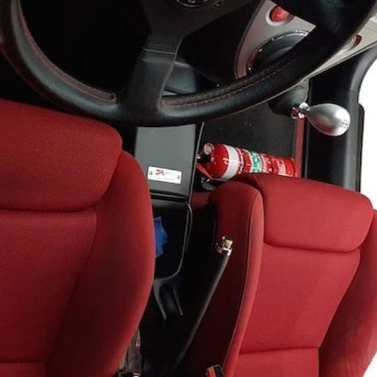 Honda Civic Type R cabin with a red fire extinguisher mounted on a KAP bracket at the base of the front seat