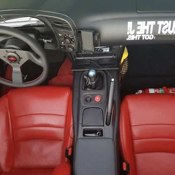 Honda S2000 cabin with a red fire extinguisher mounted on a KAP bracket at the base of the left front seat