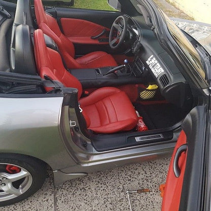Honda S2000 with the door open, showing a red fire extinguisher mounted at the base of the left front seat