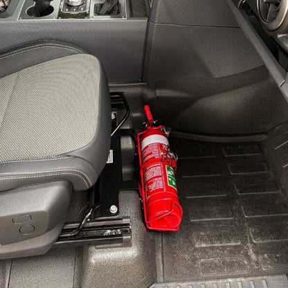 Ineos Quartermaster cabin with a red fire extinguisher mounted on a KAP bracket at the base of the front seat