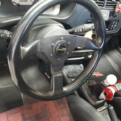 Mitsubishi Lancer Evolution VI cabin with a red fire extinguisher mounted on a KAP bracket at the base of the left front seat