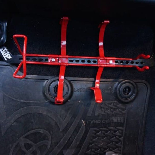 KAP bracket bolted to the front seat rails of a Toyota LandCruiser 200 Series, before the extinguisher is fitted