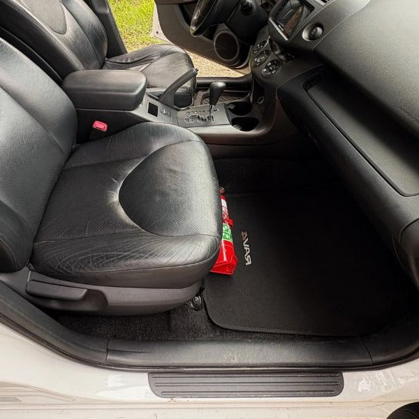 Toyota RAV4 cabin with a red fire extinguisher mounted on a KAP bracket at the base of the front seat