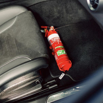 Close-up of a red fire extinguisher held in a KAP bracket at the base of the front seat in a Alfa Romeo Giulia