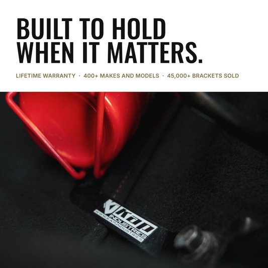 KAP bracket holding an extinguisher at the seat foot: built to hold when it matters